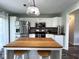 Bright kitchen features a center island, modern appliances and a stainless fridge at 3085 Oakmont Dr, Lapel, IN 46051
