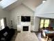 Spacious living room features hardwood floors, a fireplace, and open dining space at 3085 Oakmont Dr, Lapel, IN 46051