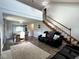 Bright living room boasts hardwood floors, staircase, and abundant natural light with open dining area at 3085 Oakmont Dr, Lapel, IN 46051
