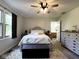 Bright bedroom features a neutral color palette, carpet, and a ceiling fan for added comfort at 3085 Oakmont Dr, Lapel, IN 46051