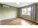 Bedroom boasts hardwood floors, a window and natural light at 32 W Michigan St, Greenfield, IN 46140