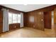 Bedroom featuring wood paneling, hardwood floors and a large window at 32 W Michigan St, Greenfield, IN 46140