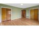 Bedroom featuring hardwood floors, green walls, closet space and natural light at 32 W Michigan St, Greenfield, IN 46140