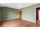This bedroom has neutral walls, hardwood floors, and a closet offering a calm, minimalist space at 32 W Michigan St, Greenfield, IN 46140