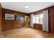 Bedroom boasts wood paneling, hardwood floors, and a large window at 32 W Michigan St, Greenfield, IN 46140