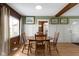The dining area offers a wooden table and chairs with natural light streaming in through a nearby window at 32 W Michigan St, Greenfield, IN 46140