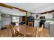 The dining area shows a wooden table with an adjacent kitchen and open view into the living area at 32 W Michigan St, Greenfield, IN 46140