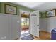 Bright entryway with hardwood floors, neutral tones, and access to the enclosed front porch, blending indoor/outdoor spaces at 32 W Michigan St, Greenfield, IN 46140