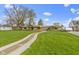A cozy single story home with a lush green lawn and stone walkway, providing an inviting and charming entrance at 32 W Michigan St, Greenfield, IN 46140