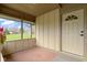 Enclosed front porch featuring neutral tones and large windows, creating a bright and inviting transition to the home's entrance at 32 W Michigan St, Greenfield, IN 46140