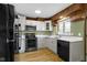 The kitchen features modern appliances, light colored cabinets, and bright countertops for a functional cooking space at 32 W Michigan St, Greenfield, IN 46140