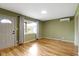 Inviting living room featuring a large window for natural light and neutral-toned walls and wood flooring at 32 W Michigan St, Greenfield, IN 46140