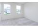 Bright bedroom with two large windows, light gray carpet and white walls at 3305 Noriker Ln, Zionsville, IN 46077