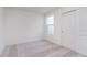 Cozy bedroom with light gray carpet, a window, and a closet with white doors at 3305 Noriker Ln, Zionsville, IN 46077