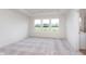 Bright bedroom with large windows, neutral carpet, and a tray ceiling at 3305 Noriker Ln, Zionsville, IN 46077