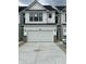 Modern two-story home with a white garage door and a concrete driveway at 3305 Noriker Ln, Zionsville, IN 46077