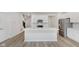 Bright, modern kitchen features stainless steel appliances, white cabinets, and large island, perfect for cooking at 3305 Noriker Ln, Zionsville, IN 46077