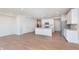 Open-concept kitchen with white cabinets, stainless steel appliances, and wood flooring at 3305 Noriker Ln, Zionsville, IN 46077