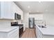 Bright kitchen with white cabinets, stainless steel appliances, and quartz countertops at 3305 Noriker Ln, Zionsville, IN 46077