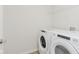 A well-equipped laundry room features modern, front-load washer and dryer appliances at 3305 Noriker Ln, Zionsville, IN 46077