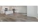 Open floor plan with modern kitchen flowing into a spacious living area with wood-look floors at 3305 Noriker Ln, Zionsville, IN 46077