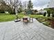 Landscaped backyard featuring a patio set, umbrella, and lush green space at 337 Leaning Tree Rd, Greenwood, IN 46142