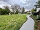 Spacious backyard with garden beds, fire pit, and mature trees at 337 Leaning Tree Rd, Greenwood, IN 46142