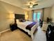 Inviting bedroom with neutral carpet, black furniture, bedside lamps, a window, and a ceiling fan at 337 Leaning Tree Rd, Greenwood, IN 46142