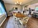 Inviting dining room features wood look flooring, lots of sunlight and views into the kitchen at 337 Leaning Tree Rd, Greenwood, IN 46142