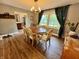 Bright dining room with wood floors, elegant lighting, and a view to the outside at 337 Leaning Tree Rd, Greenwood, IN 46142