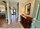 Inviting foyer features wood look flooring, a side table with lamp and a large mirror at 337 Leaning Tree Rd, Greenwood, IN 46142