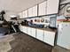 Cluttered garage with white cabinets and a workbench at 337 Leaning Tree Rd, Greenwood, IN 46142