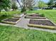 View of wooden framed garden beds in a spacious yard at 337 Leaning Tree Rd, Greenwood, IN 46142