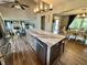 Open kitchen with island seating, stainless steel dishwasher and views into the living and dining rooms at 337 Leaning Tree Rd, Greenwood, IN 46142