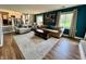Spacious living room with modern decor, a large rug, and windows overlooking the lawn at 337 Leaning Tree Rd, Greenwood, IN 46142