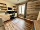 Home office with rustic wood accent wall, built in shelving, and a modern desk setup at 337 Leaning Tree Rd, Greenwood, IN 46142
