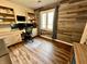 Well-lit home office with wooden accent wall, custom built-ins, and desk area at 337 Leaning Tree Rd, Greenwood, IN 46142