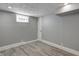 Basement with window and modern gray vinyl plank flooring at 3549 N Sherman Dr, Indianapolis, IN 46218