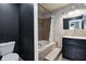Bathroom with tiled tub, shower, vanity, and toilet at 3549 N Sherman Dr, Indianapolis, IN 46218
