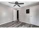 Bedroom with ceiling fan, closet, and modern gray vinyl plank flooring at 3549 N Sherman Dr, Indianapolis, IN 46218