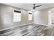An empty bedroom with new flooring, ceiling fan, and a view of the backyard at 3549 N Sherman Dr, Indianapolis, IN 46218
