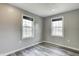 Bedroom with two windows and modern gray vinyl plank flooring at 3549 N Sherman Dr, Indianapolis, IN 46218