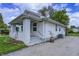 Exterior view of a white siding home with a brick porch and a partial lawn at 3549 N Sherman Dr, Indianapolis, IN 46218