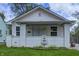 Charming home featuring white brick, siding, and a unique lion head fountain at 3549 N Sherman Dr, Indianapolis, IN 46218