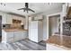 White kitchen featuring stone countertops, a ceiling fan, and bright lighting at 3549 N Sherman Dr, Indianapolis, IN 46218