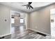 Spacious living room with ceiling fan, open floor plan, and modern gray vinyl plank flooring at 3549 N Sherman Dr, Indianapolis, IN 46218