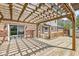 Outdoor deck features a wood pergola, offering a relaxing space for entertaining with an attached brick home at 4152 S Creekside Dr, New Palestine, IN 46163