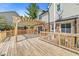 View of the back deck with a wooden pergola covering part of the deck, and a home with beige siding at 4152 S Creekside Dr, New Palestine, IN 46163