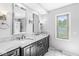 Bathroom featuring a double vanity with marble countertops, a window with natural light and tile floors at 4152 S Creekside Dr, New Palestine, IN 46163