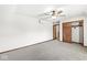 Bedroom featuring neutral carpet, wood trim, dark wooden doors and a ceiling fan at 4152 S Creekside Dr, New Palestine, IN 46163